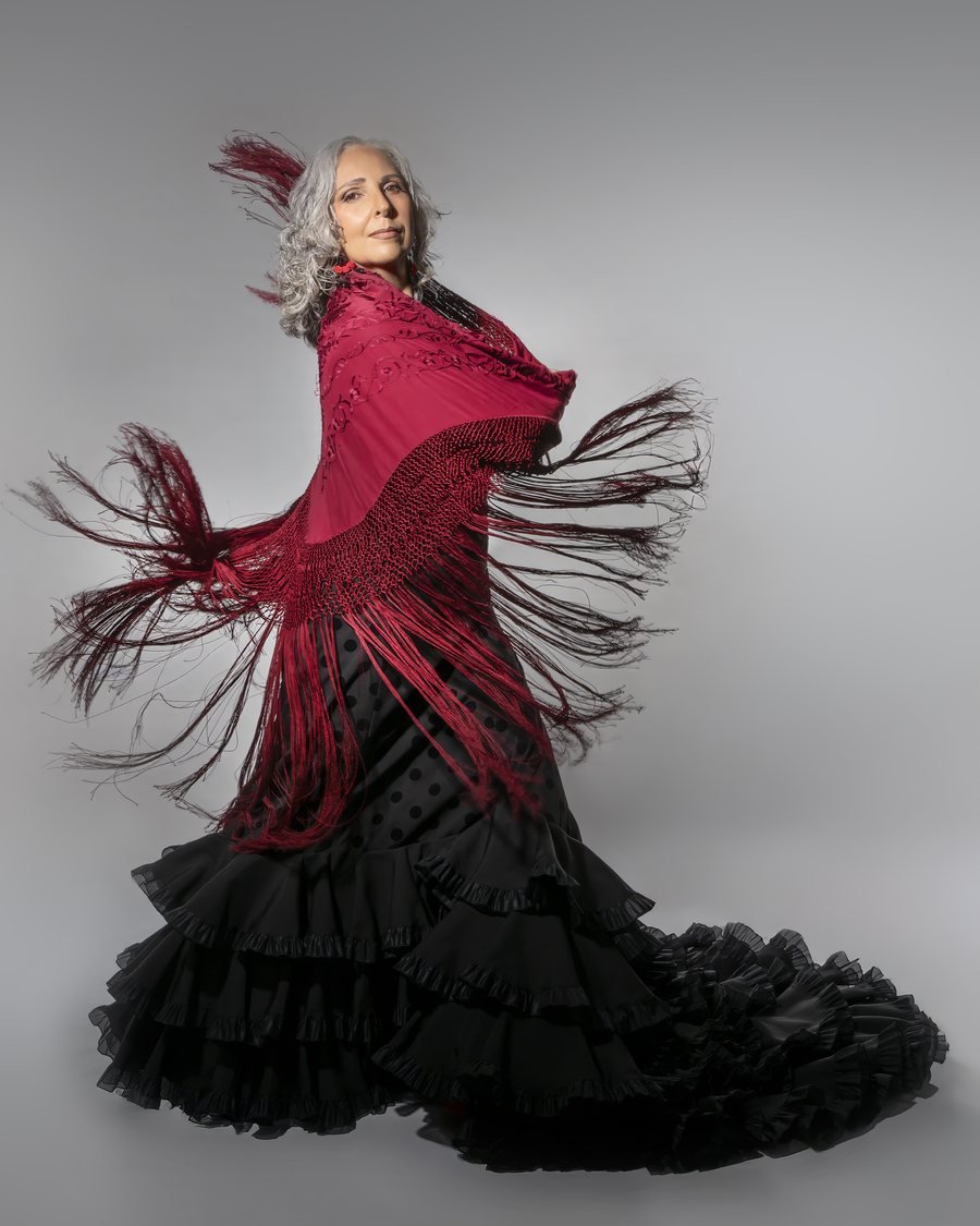 Rocío Pozo bailando sevillanas con mantón rojo y falda de volantes